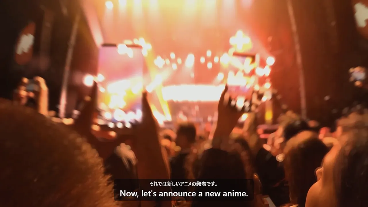 A concert stage with lights and a crowd, with English subtitles over the video